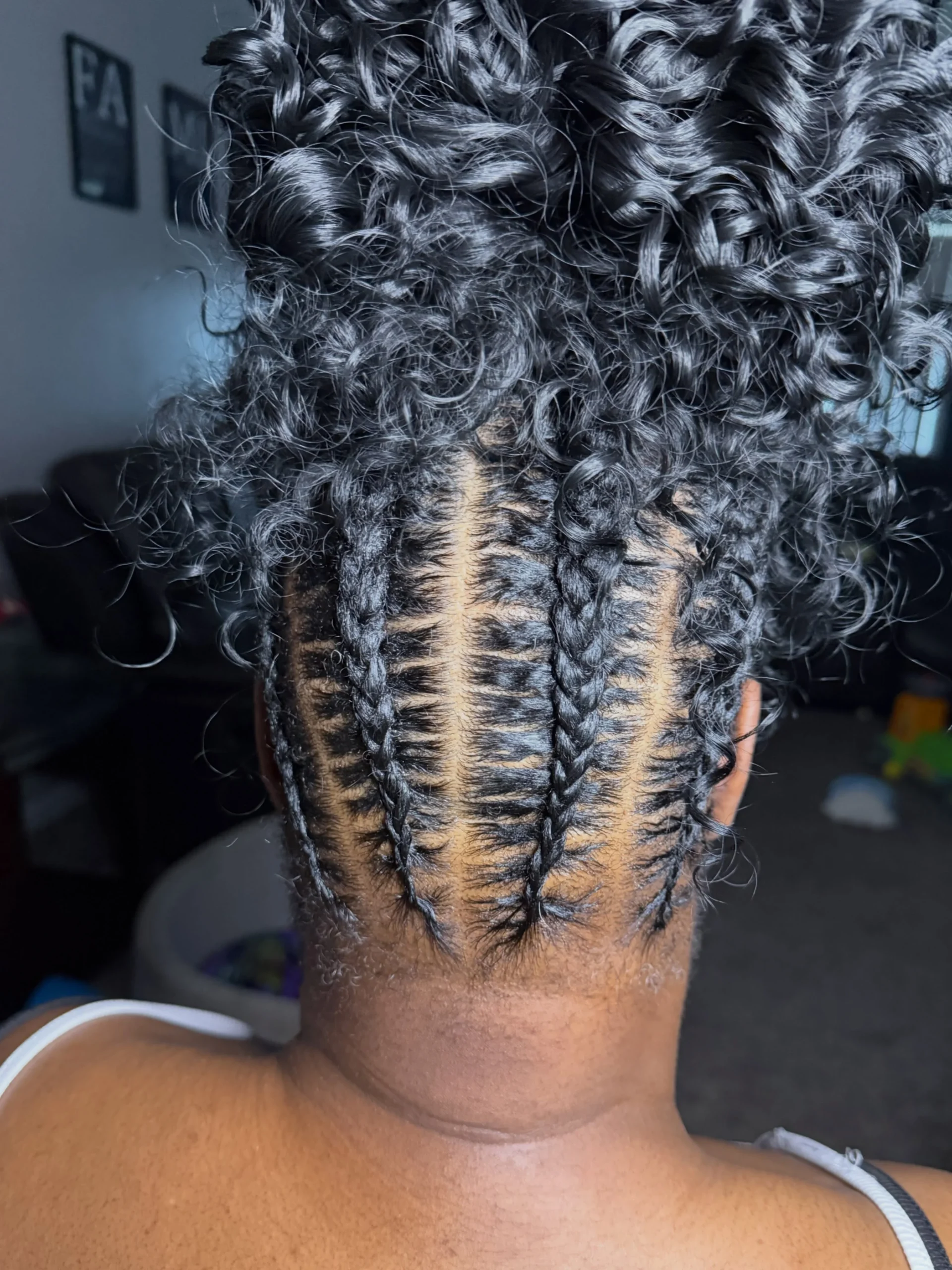 Straight back cornrows with a loose wave bun