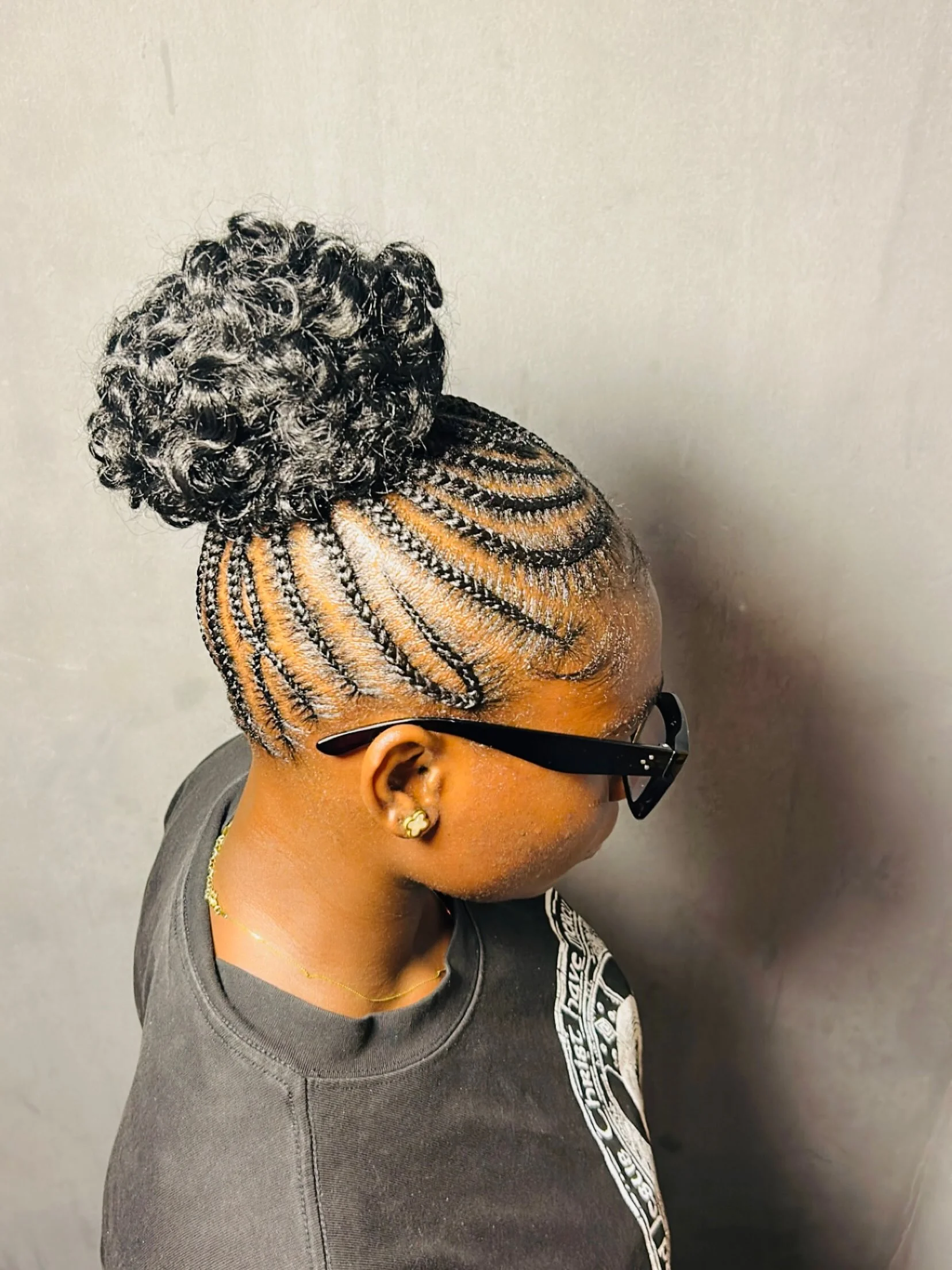 Curved cornrows into a textured high bun