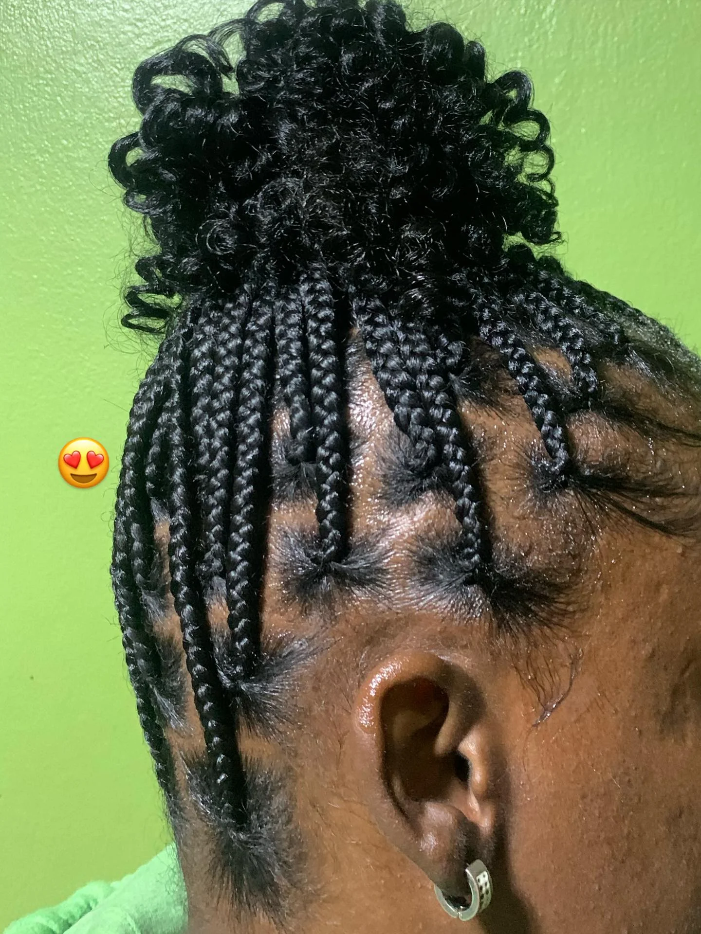 Thin box braids into a full curly top knot