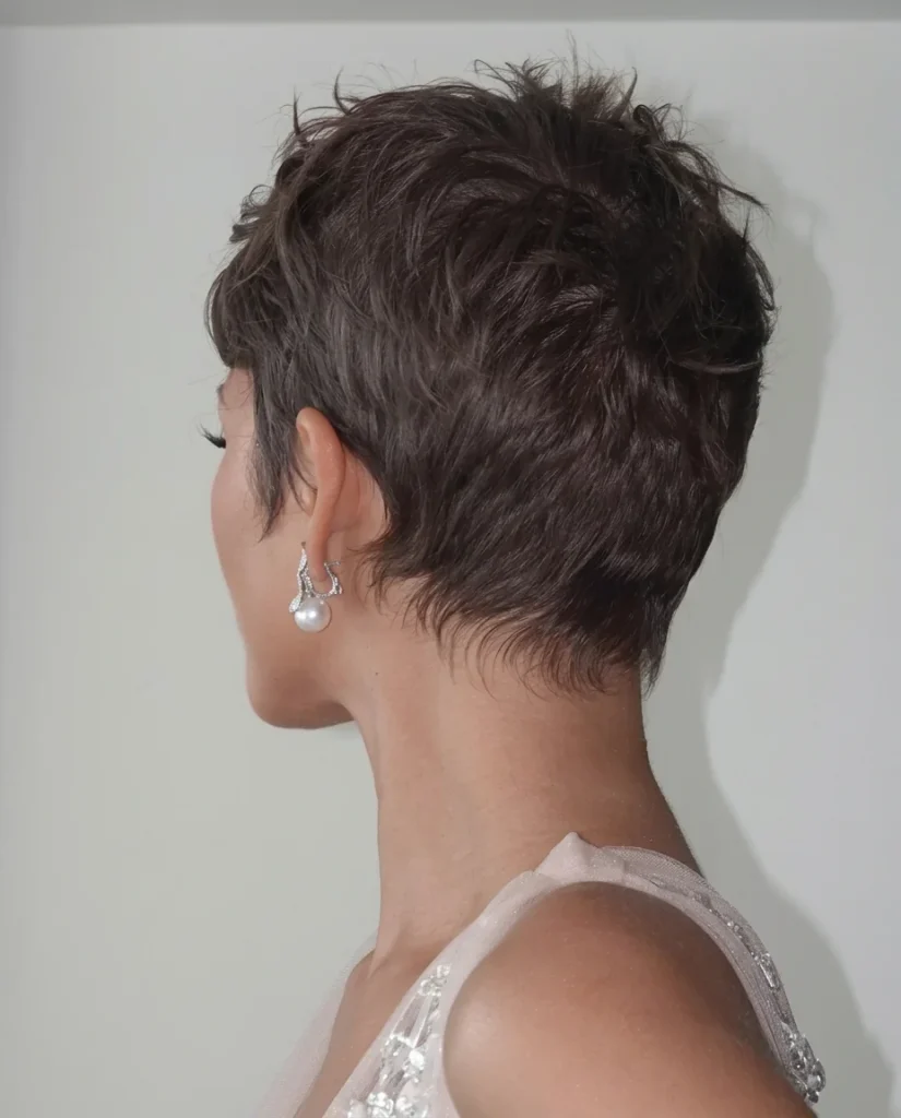 Back view of a textured gamine pixie with tapered nape and pearl earring
