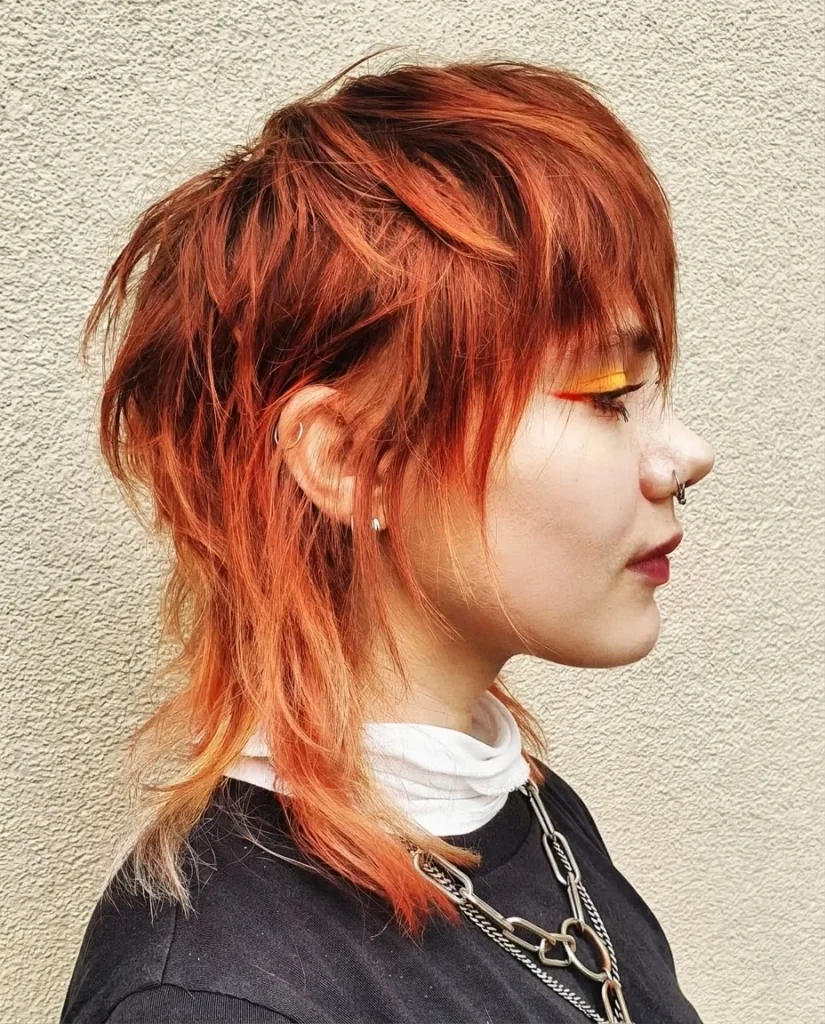 Copper wolf mullet with choppy layers and peach blonde ends, side profile
