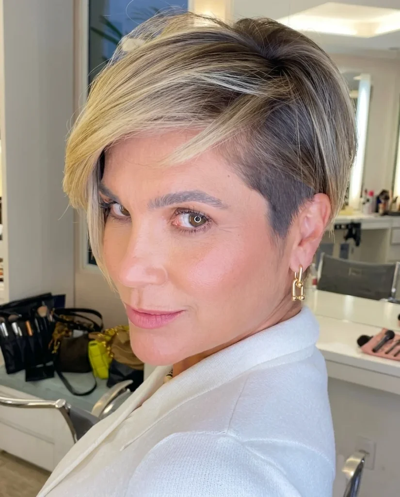 Undercut pixie with long swept fringe and blonde highlights