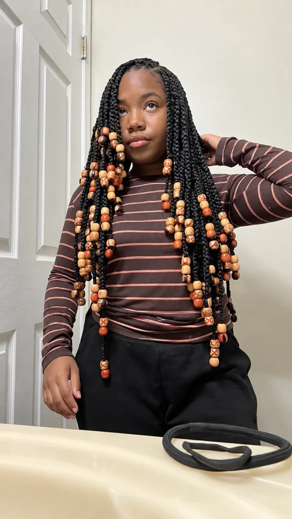 Jumbo box braids with orange and cream patterned wooden beads