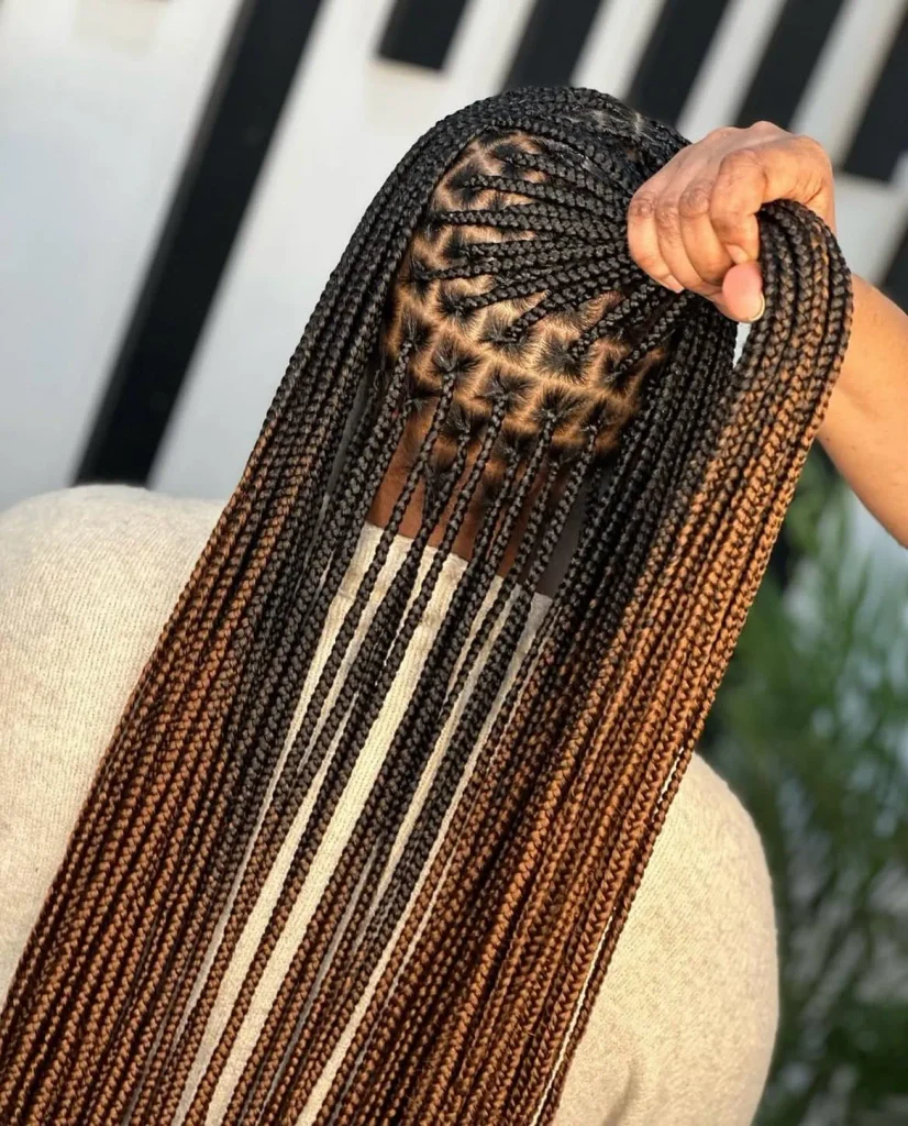 Long knotless braids with a black to caramel ombré and triangle parts