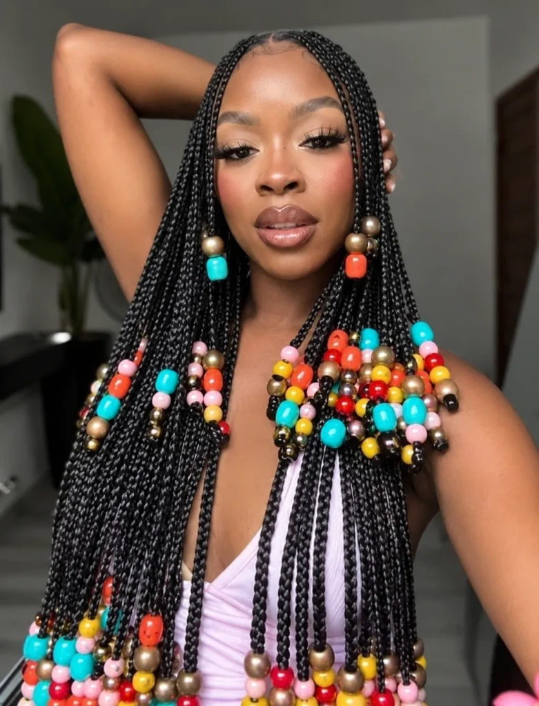 Long box braids with turquoise, coral, yellow, pink and gold beads