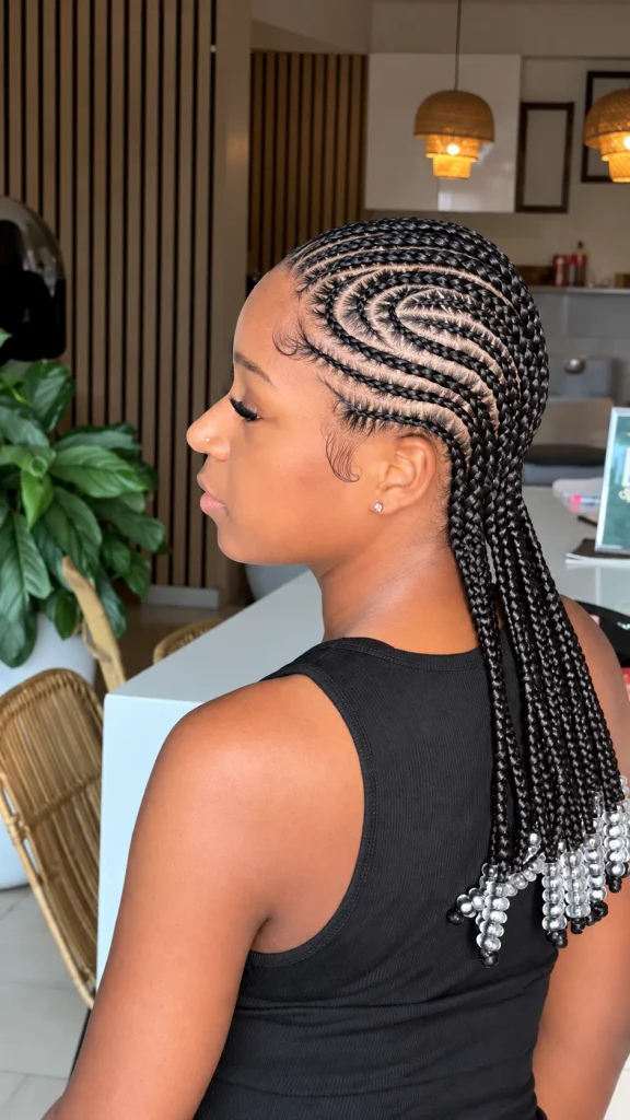 Side-swirl cornrows with clear silver-toned beads on shoulder-length braids