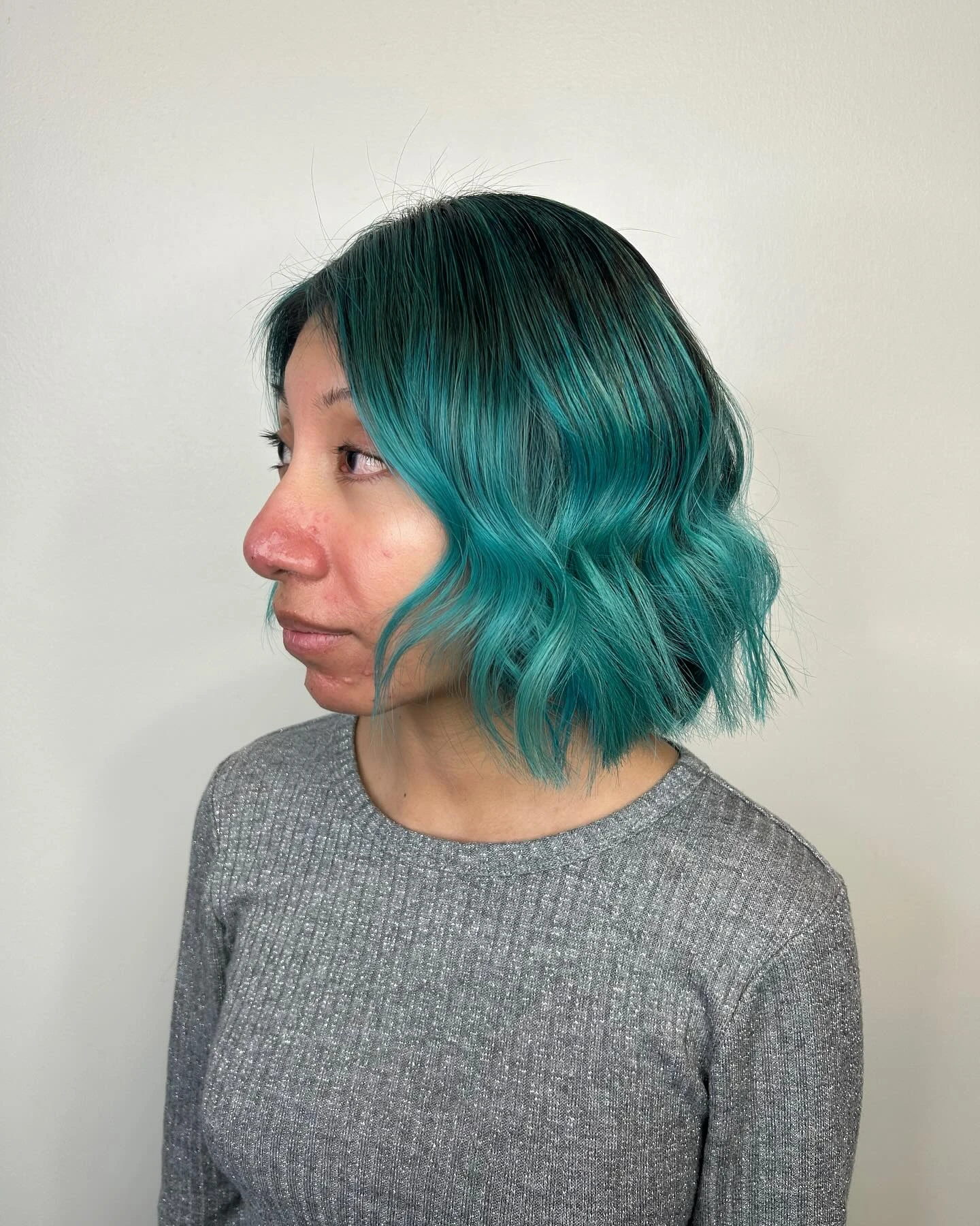 Chin length blunt bob in teal turquoise